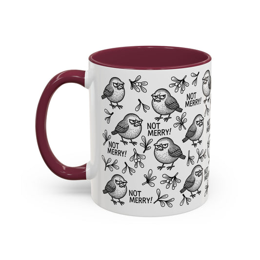 White mug with grumpy robin illustrations and 'Not Merry!' text with contrasting burgundy interior and handle.