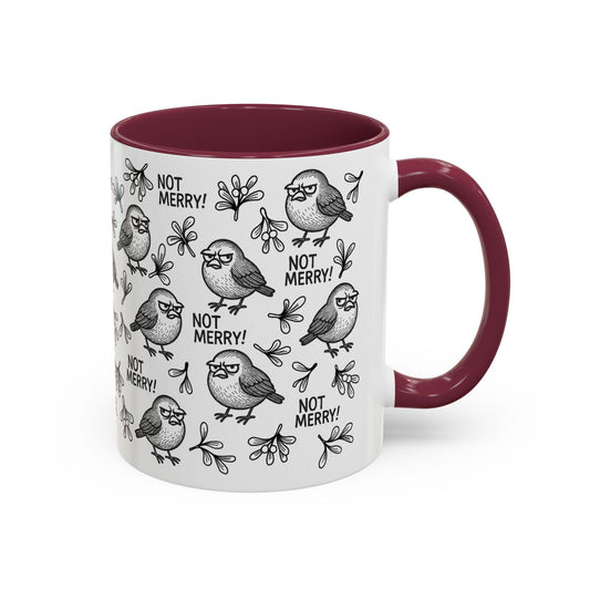 White mug with grumpy robin illustrations and 'Not Merry!' text with contrasting burgundy interior and handle.