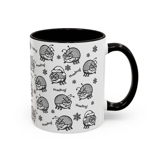 Mug with black and white 'Humbug!' beetle pattern on a white background with contrasting black interior and handle.